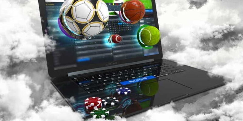 can you make money sports online betting - computer in the clouds with sports balls flying from the screen