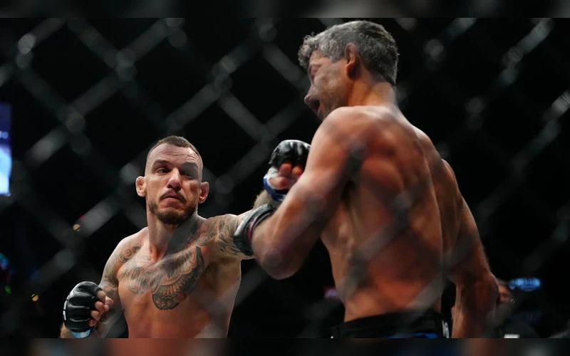 Renato Moicano exchanges strikes with an opponent during a UFC fight inside the Octagon